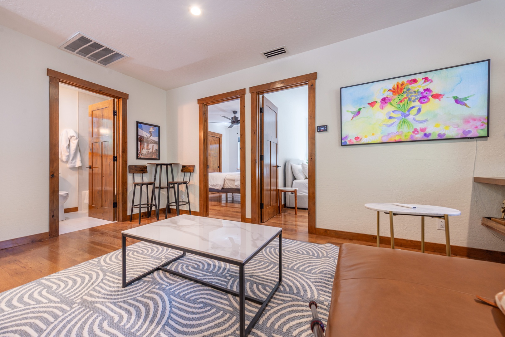 Your inviting living space opens to bright rooms throughout, featuring warm wood accents and a cozy layout perfect for gathering. Settle in and make yourself at home.
