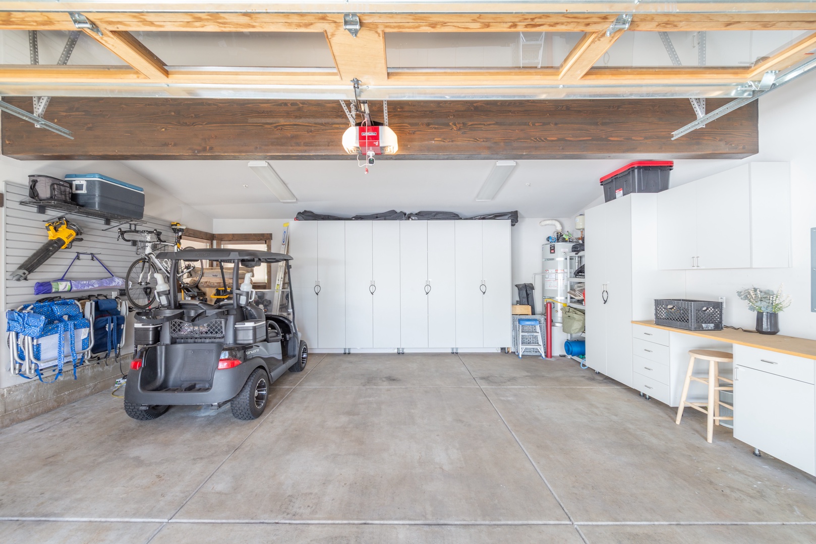 Your private garage offers secure parking and organized storage with sleek white cabinets and counter space for all your travel needs.