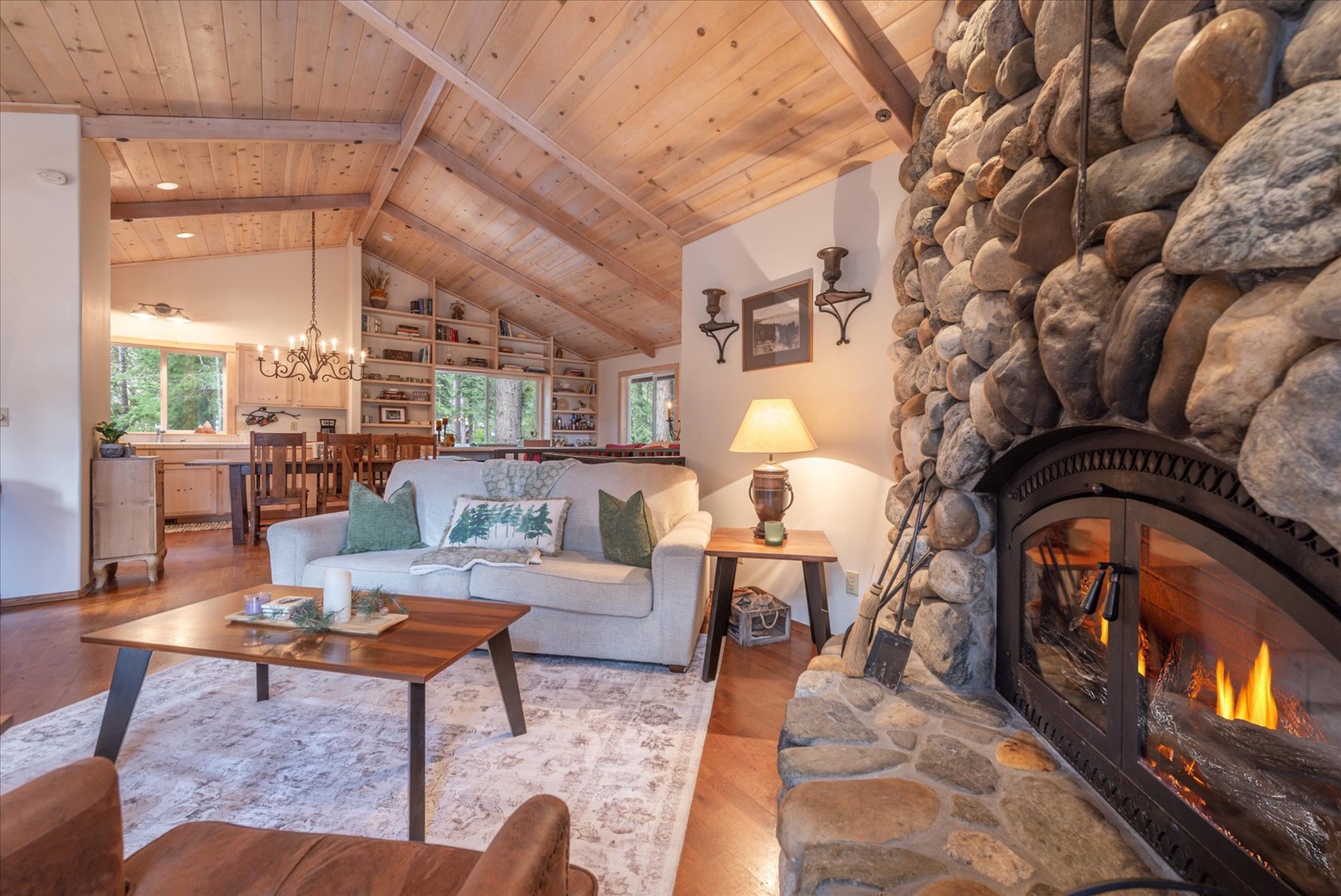 Modern comfort awaits as you unwind by the stone fireplace in this perfectly appointed open-concept living space.