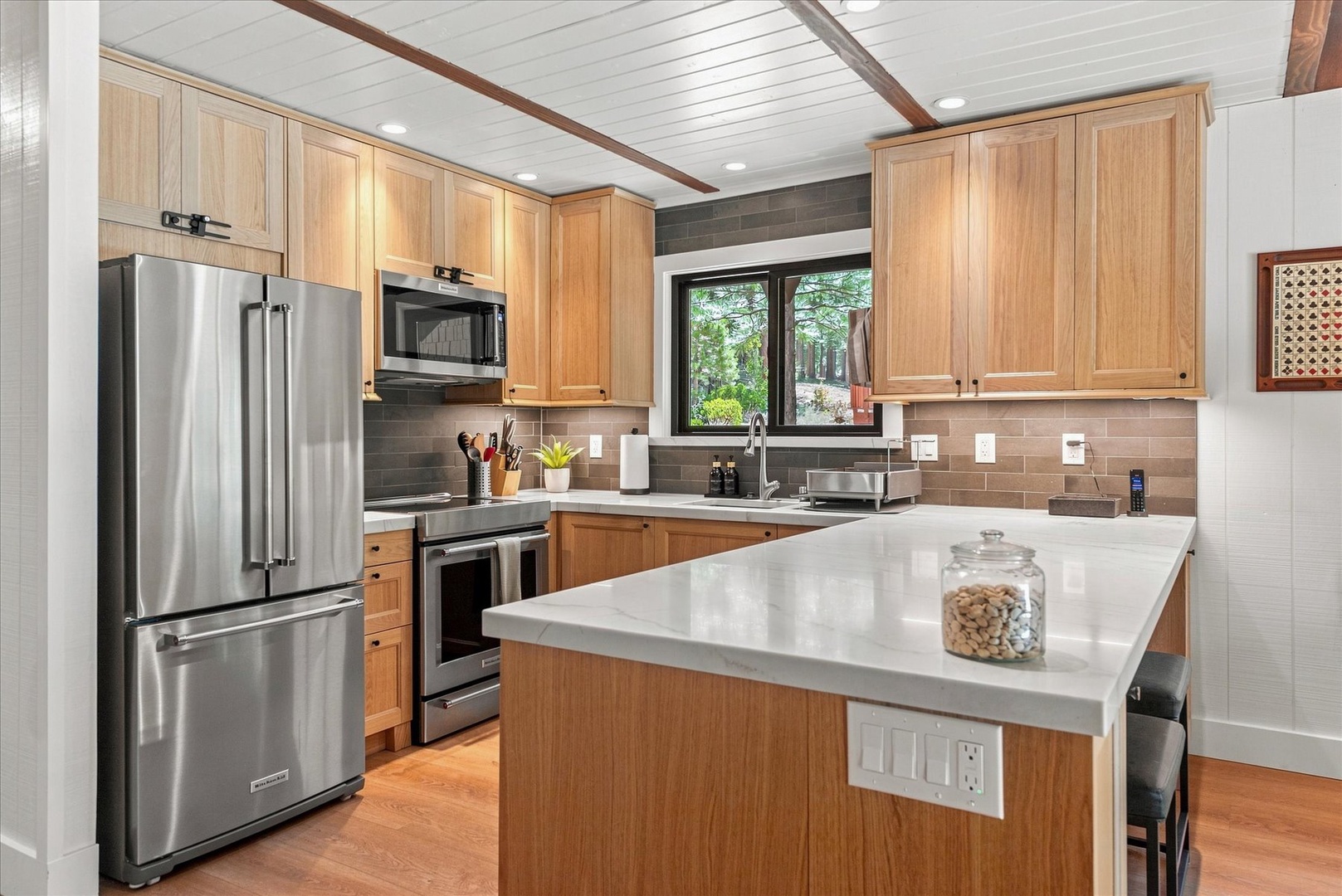 Your kitchen boasts gleaming stainless steel appliances, warm wood cabinetry, and a bright center island—perfect for cooking up vacation memories.