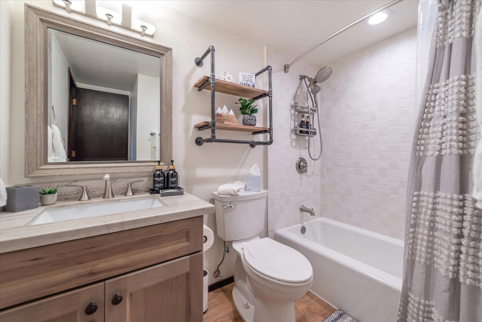 Unwind in your stylish bathroom featuring modern amenities, thoughtful storage, and a relaxing tub perfect for soaking after your adventures.