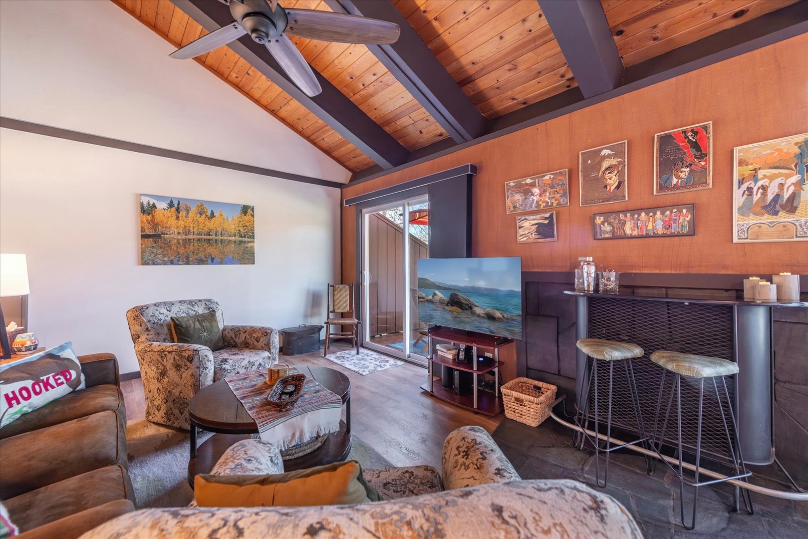 Curl up in this warm living room where exposed beams, cabin decor, and cozy seating create your perfect mountain retreat.