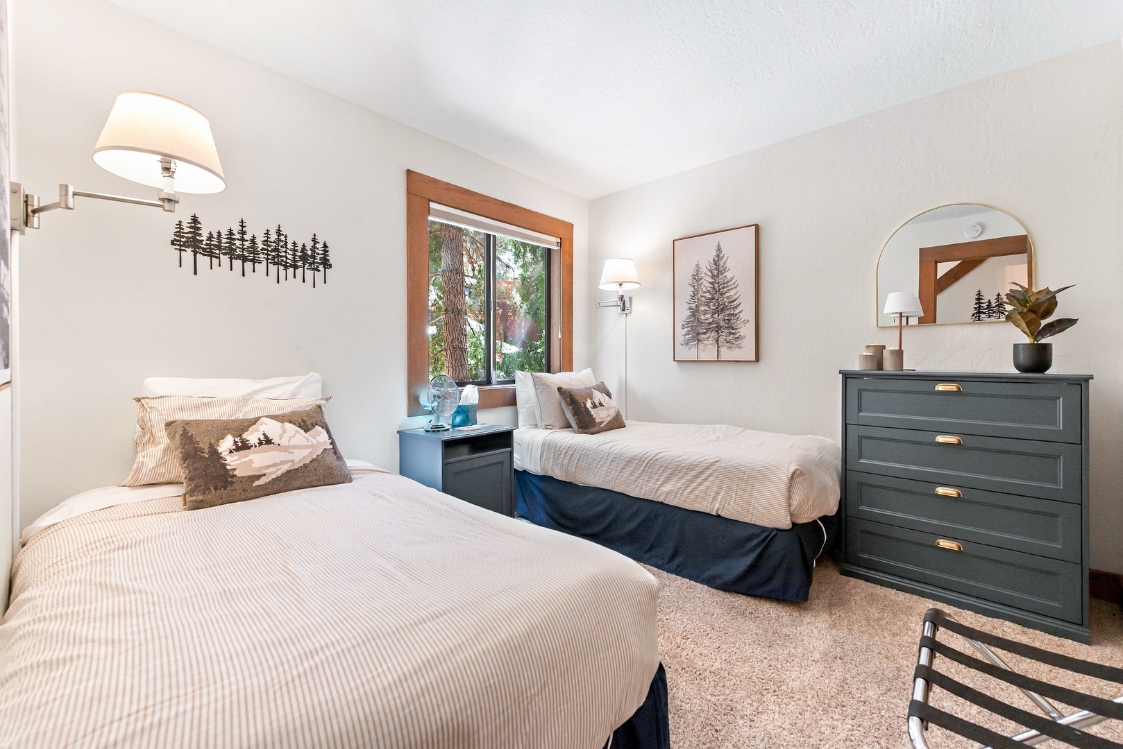Your peaceful retreat awaits with two cozy beds, natural light streaming through the window, and thoughtful mountain-inspired touches that make you feel right at home.