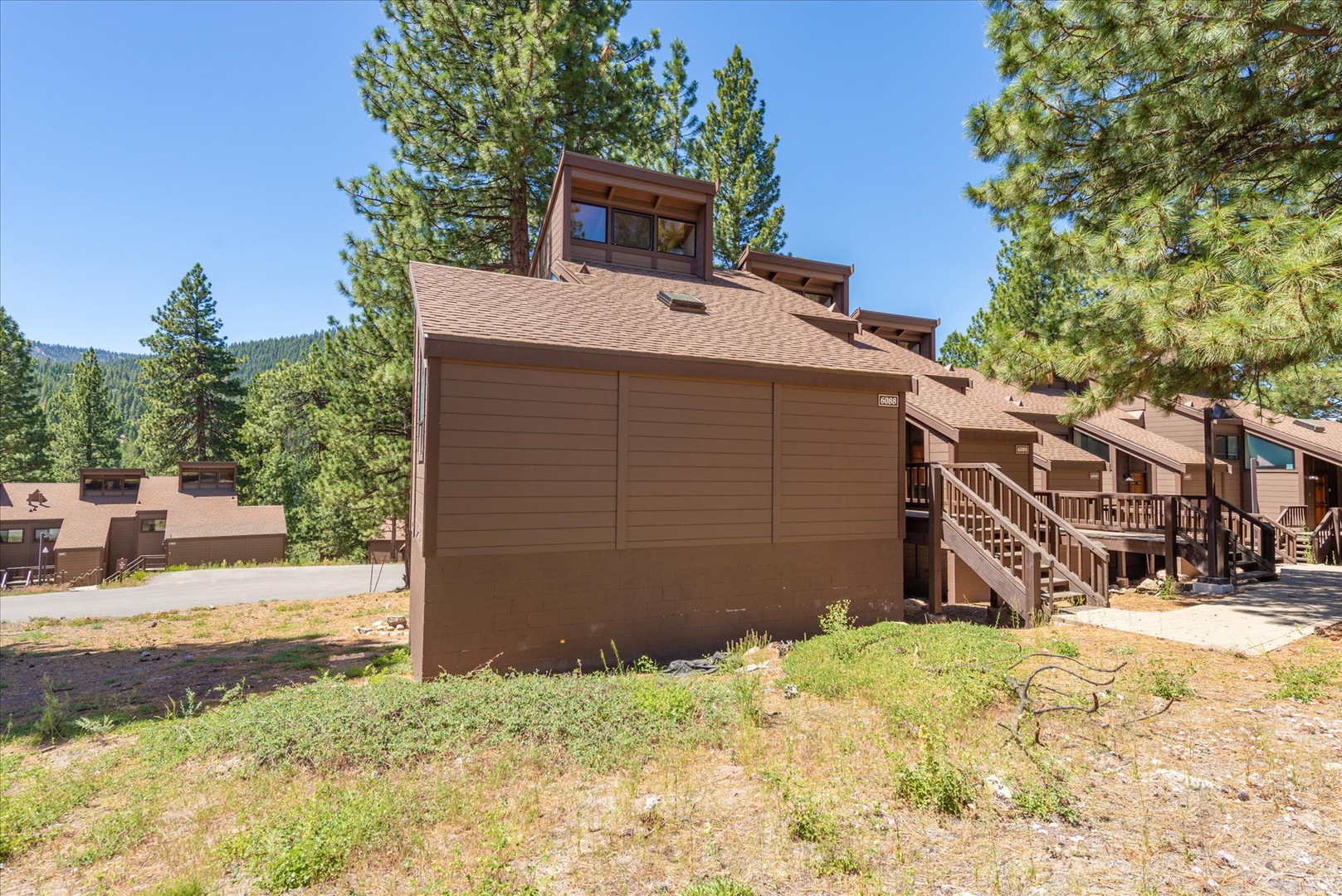 A mountain retreat surrounded by tall pines, offering a peaceful wooded setting with scenic forest views just beyond the property.