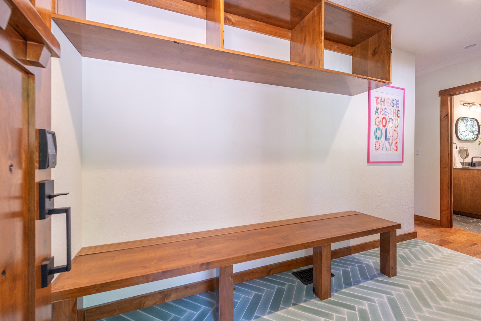 A bright, open-plan space with warm wood accents and modern geometric flooring invites you to relax and feel right at home.