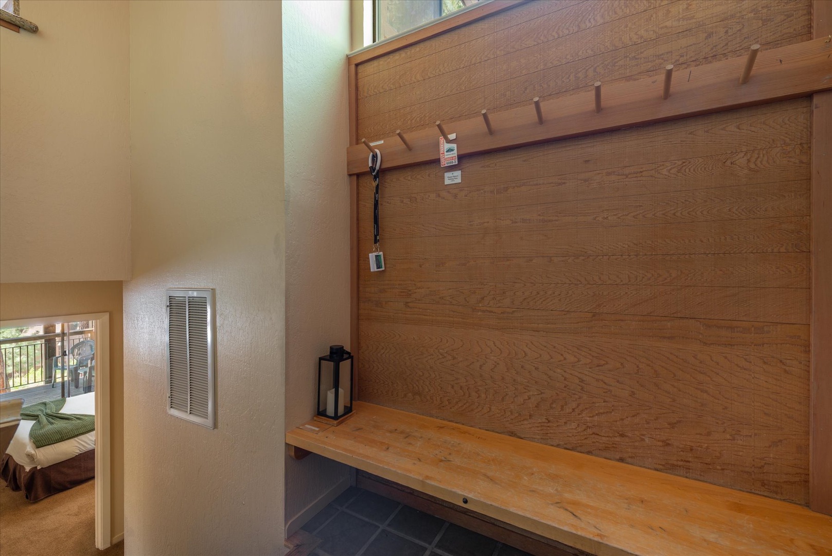 Your own entryway nook with a wooden bench and hooks awaits, perfect for stashing gear after a day of adventure or kicking off shoes as you settle in.