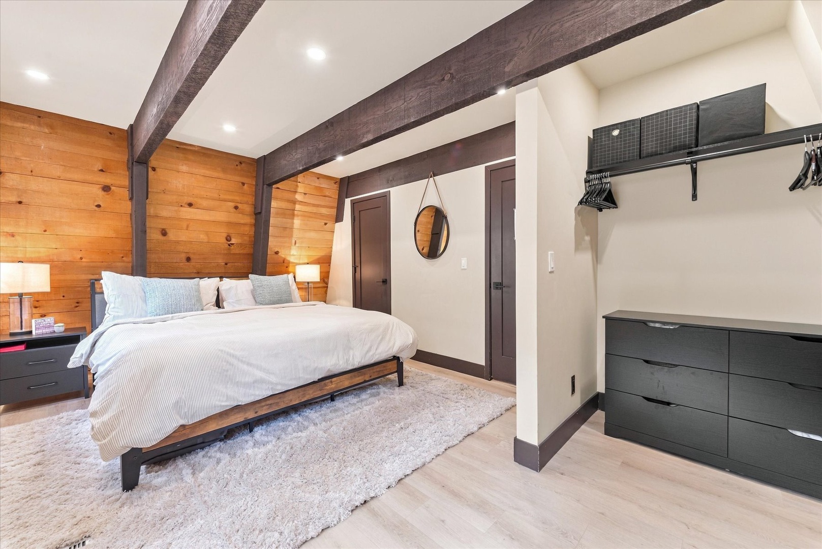 Sink into bed beneath dramatic exposed beams in your master bedroom, where warm wood tones and crisp linens create your perfect mountain retreat. Unpack in style with ample storage in this exposed closet.