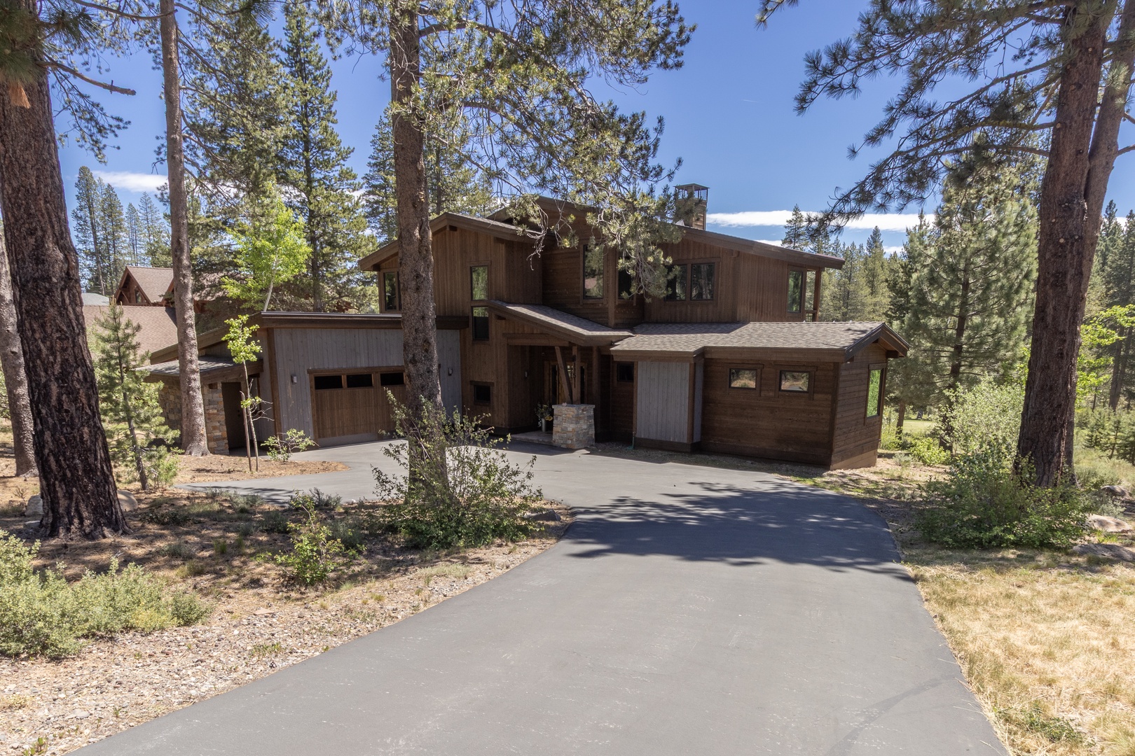 This beautiful wooden mountain home sits nestled among towering pines, offering a peaceful forest setting with convenient paved driveway access and a welcoming two-story design perfect for your mountain getaway.