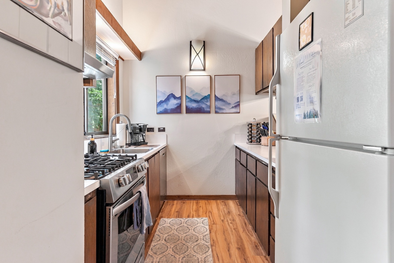 Your fully equipped galley kitchen has everything you need—modern appliances, natural light through the window, and sleek cabinets for easy meal prep.