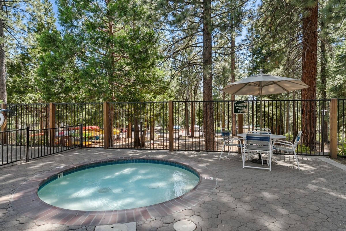 Soak away your stress in this hot tub surrounded by trees, where mountain serenity meets your perfect escape.