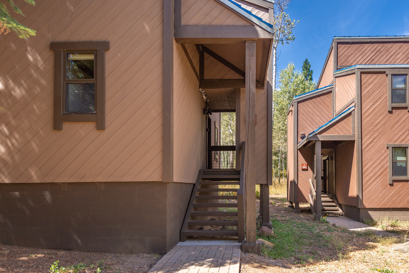 Two contemporary vacation homes sit nestled among aspens and evergreens in a peaceful mountain setting, providing private yet accessible accommodations for your stay.