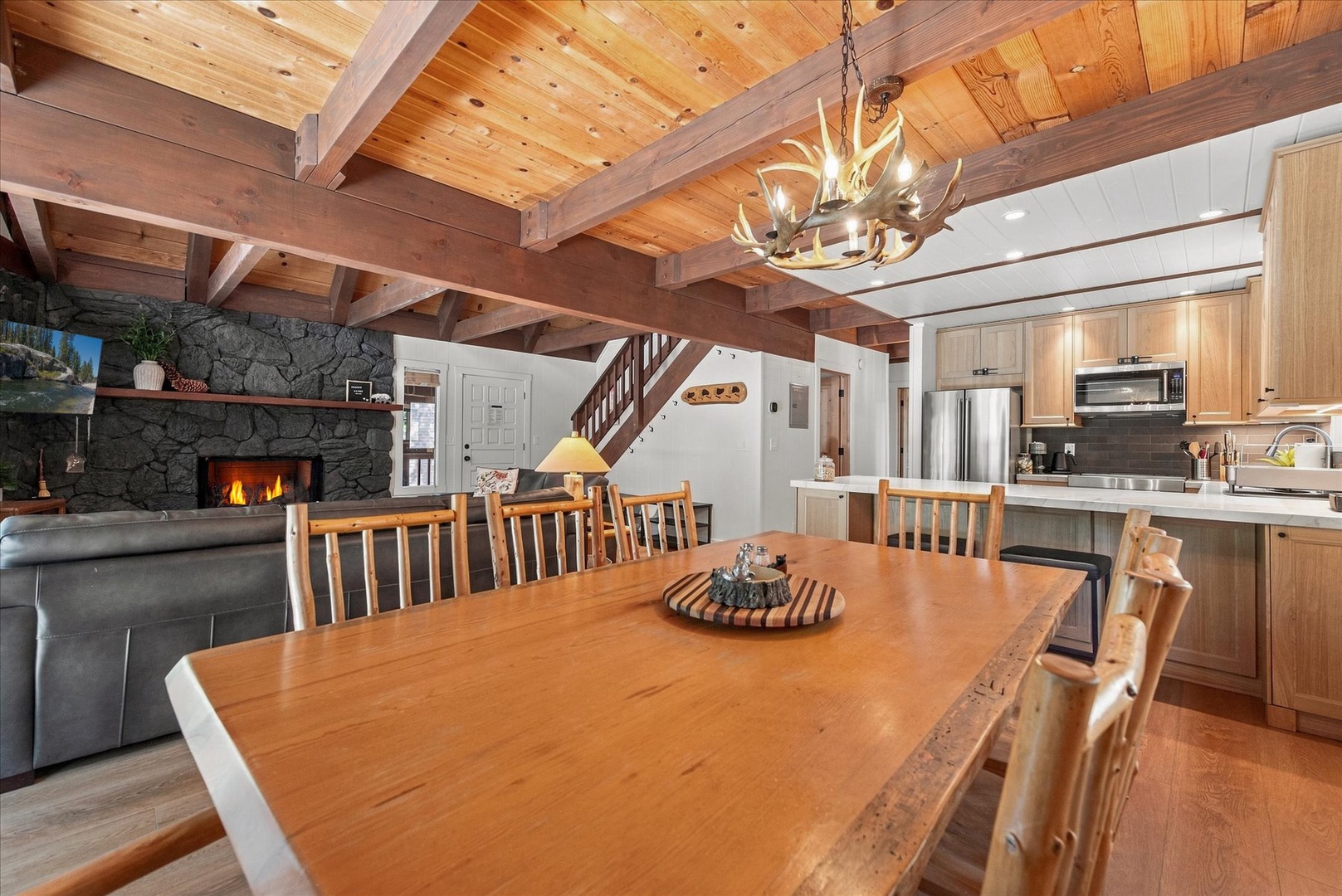 Gather around the table beneath the antler chandelier as you savor mountain moments together in this cozy, inviting space.