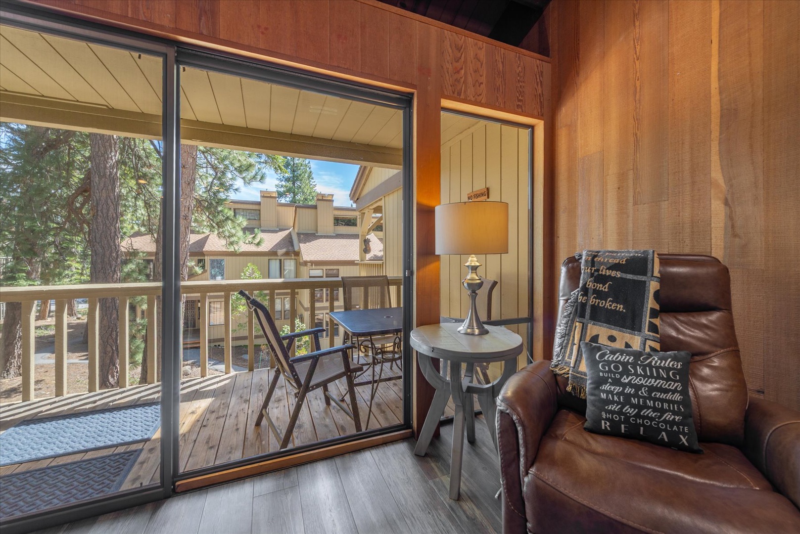 Cozy up in your leather chair with forest views streaming through floor-to-ceiling windows, then step onto your private deck for fresh mountain air.