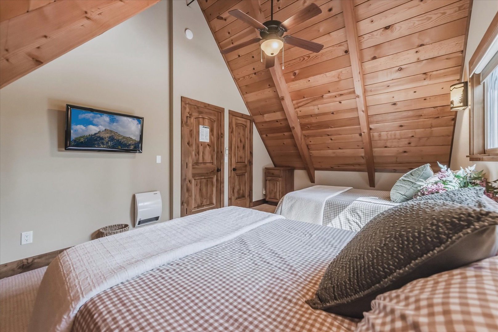 This spacious upstairs room with two plush queen beds has it's own TV and plenty of room for family or friends.