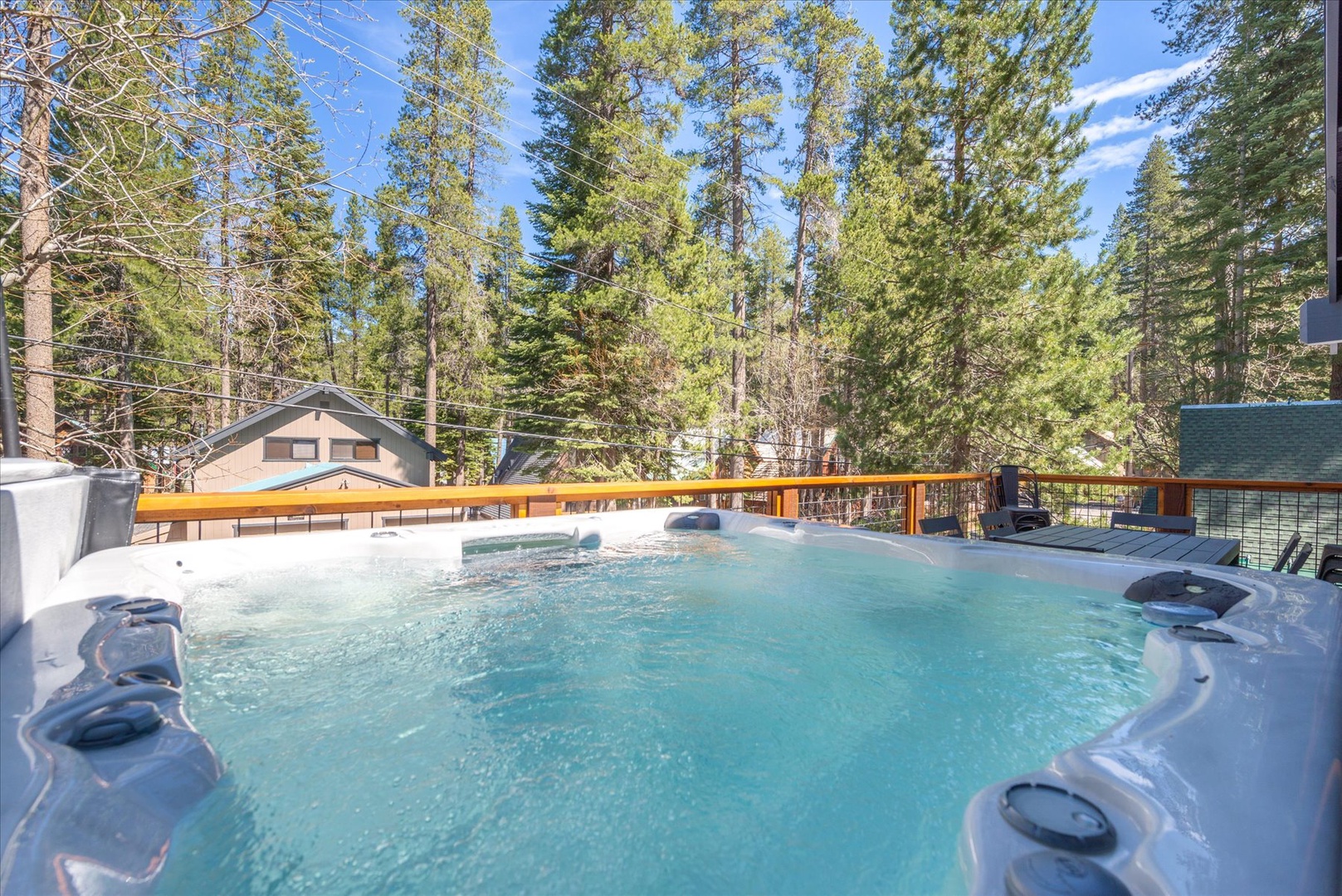 Soak in your private hot tub surrounded by towering pines and mountain air, where warm bubbles and forest views create the perfect alpine retreat.