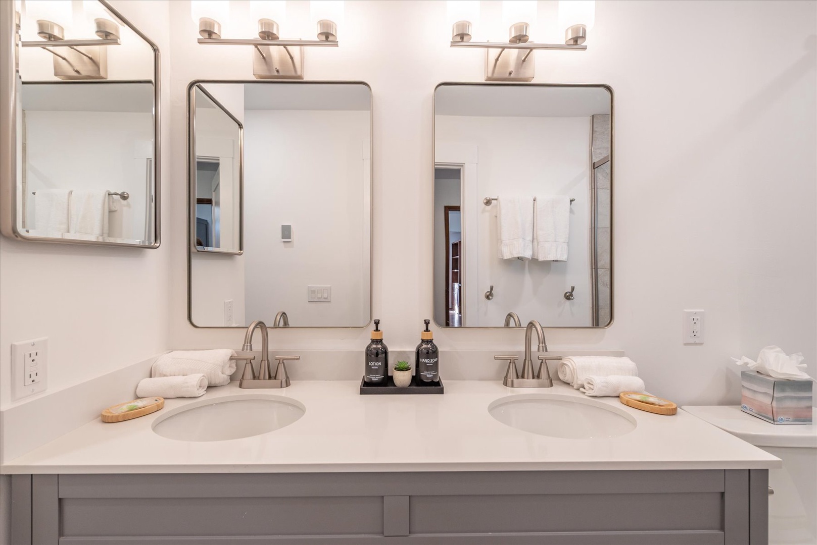 Refresh in your spacious dual-vanity bathroom with premium amenities and warm lighting creating the perfect morning routine.