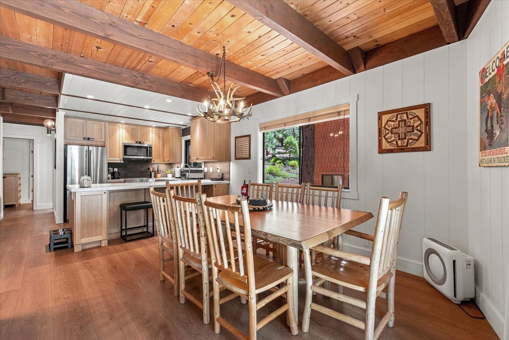 Gather around the farmhouse dining table where your group can share meals, laughter, and stories in this warm, inviting space with a fully-equipped kitchen just steps away.