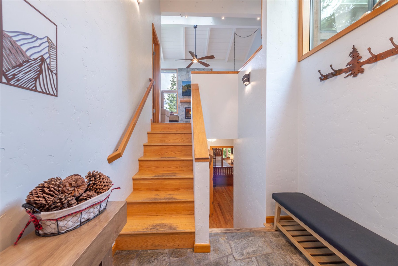 Bright entryway with thoughtful details like a bench and coat hooks to unload from your mountain adventure.