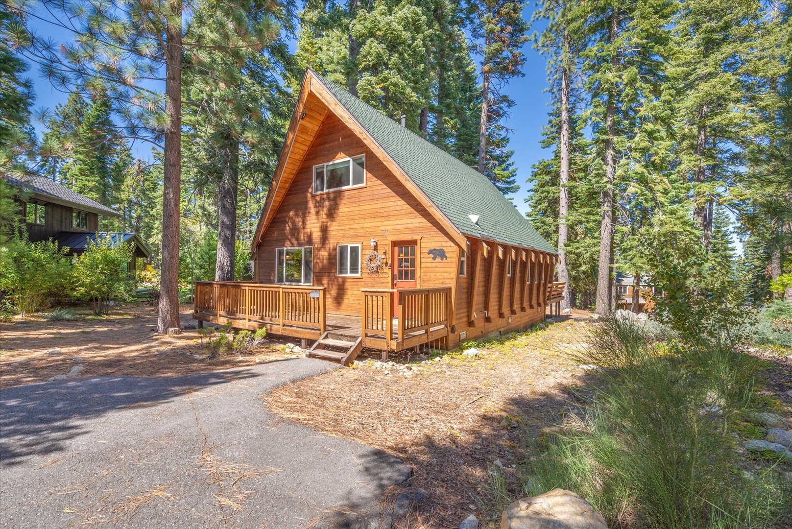 A charming A-frame cabin nestled among towering pines.