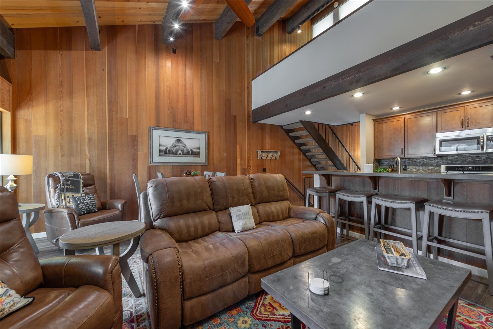 Unwind in your mountain retreat with rich wood beams, leather seating, and an open kitchen perfect for après-ski gatherings.