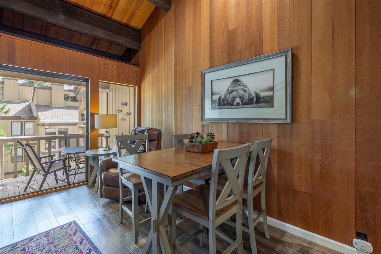 Gather around this welcoming dining table where warm wood walls and mountain views create the perfect setting for your memorable meals together.