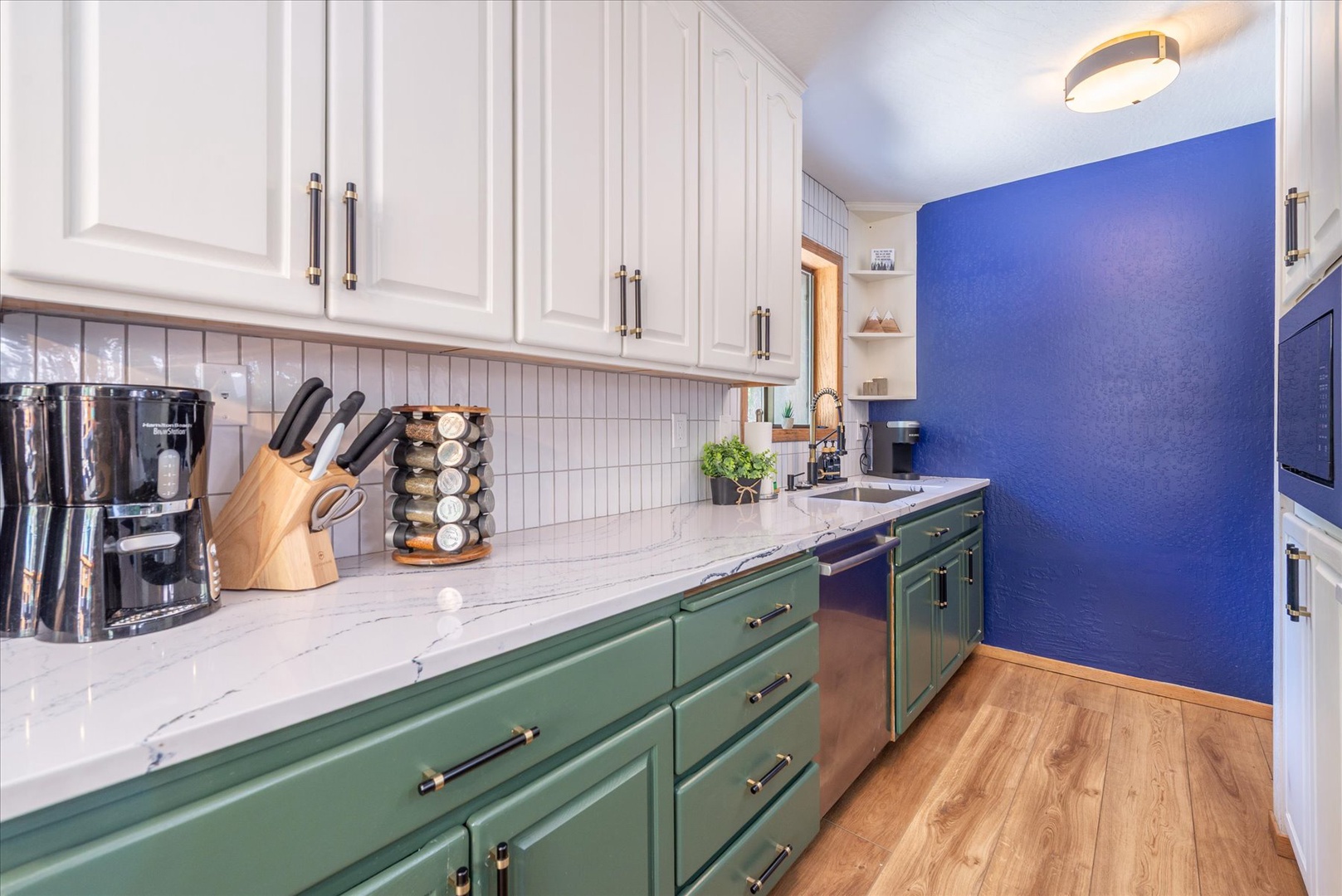 Your fully equipped kitchen awaits with marble counters, quality appliances, and charming two-tone cabinetry for memorable meal prep.