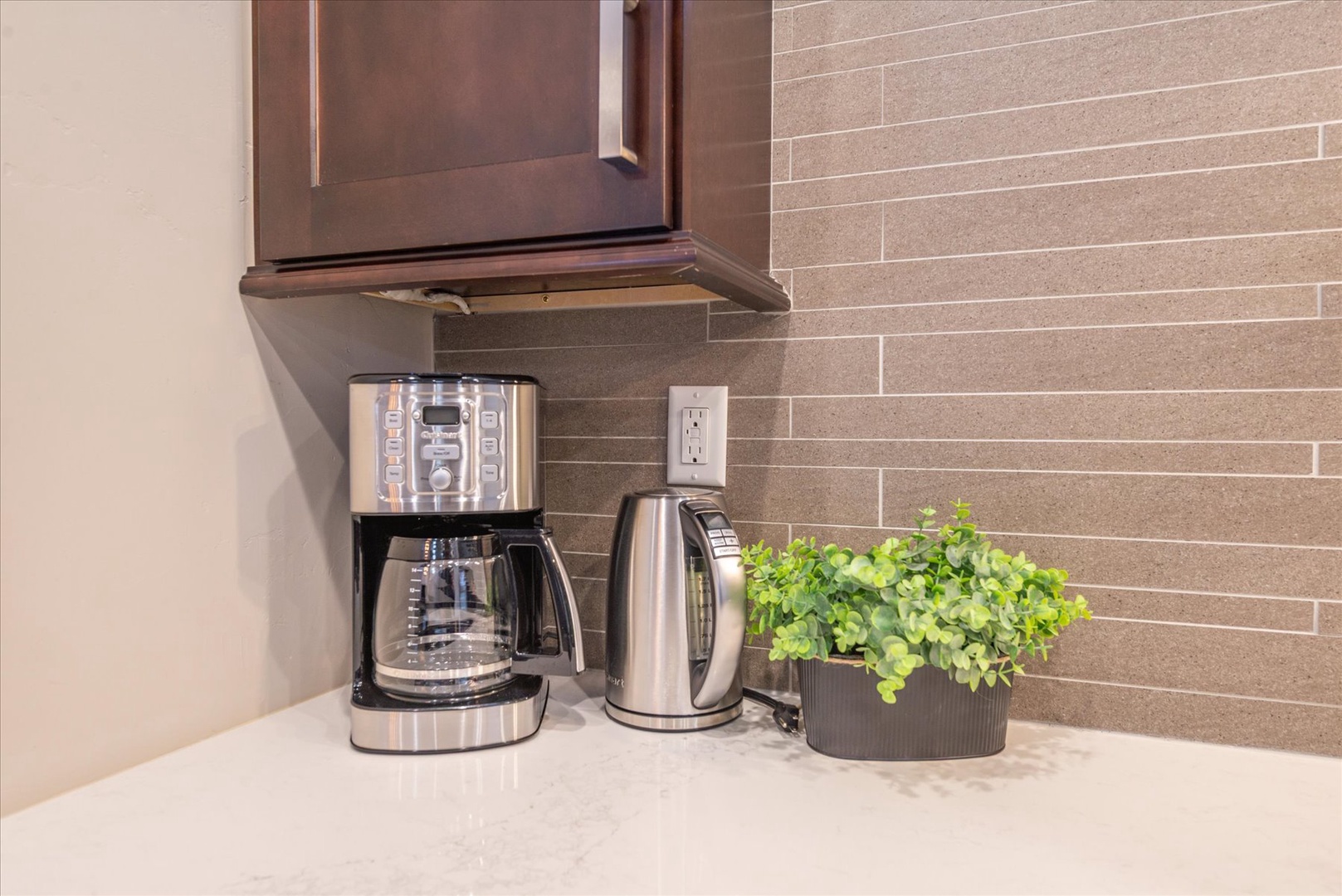 Your morning coffee awaits with premium appliances at your fingertips in this thoughtfully equipped kitchen corner.