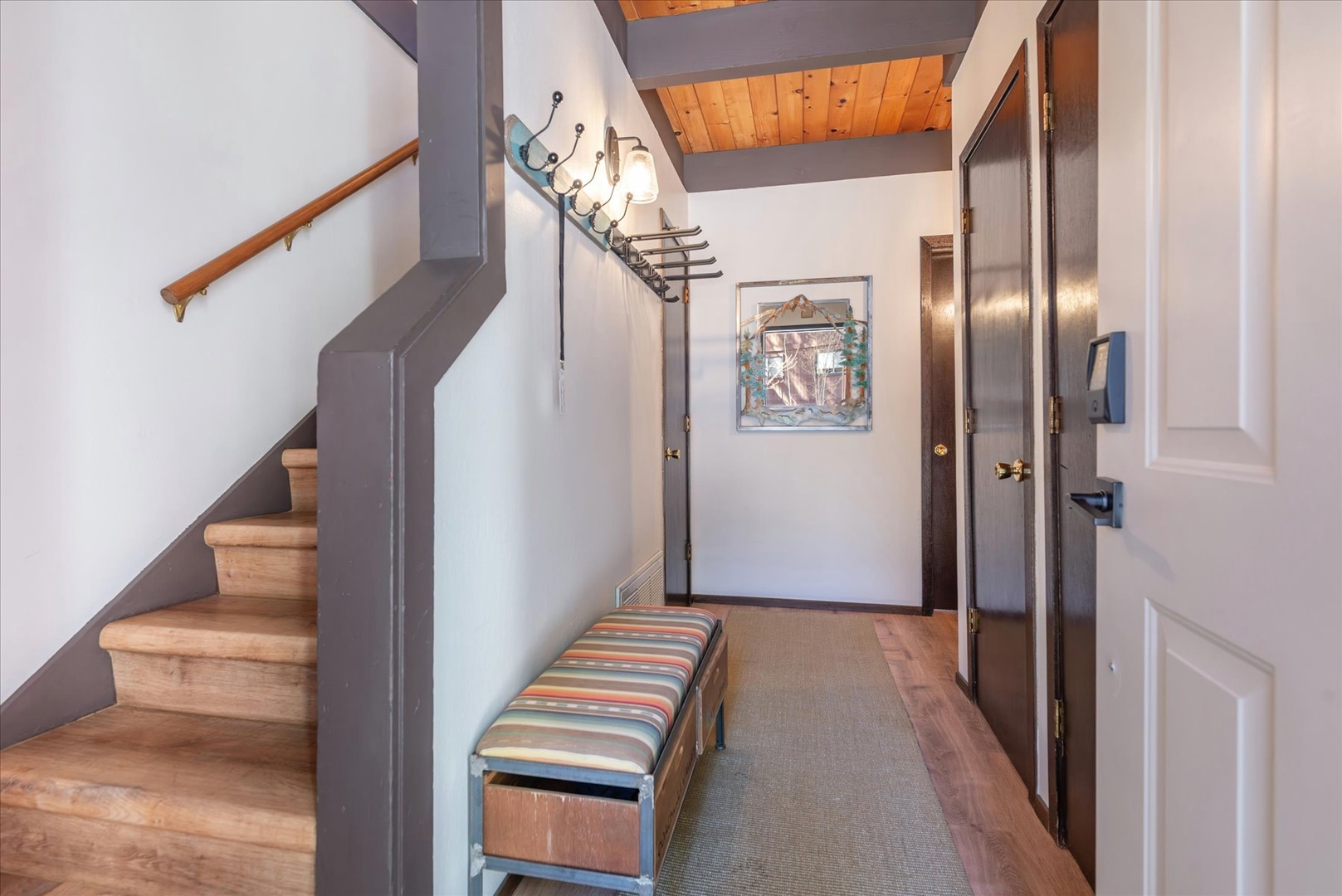 Step into your welcoming entryway with warm wood accents and mountain charm, where rustic beams meet modern comfort.