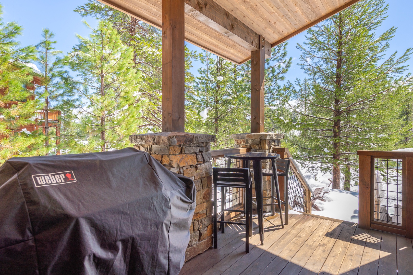 Fire up your Weber grill on this covered deck while soaking in forest views through the trees.