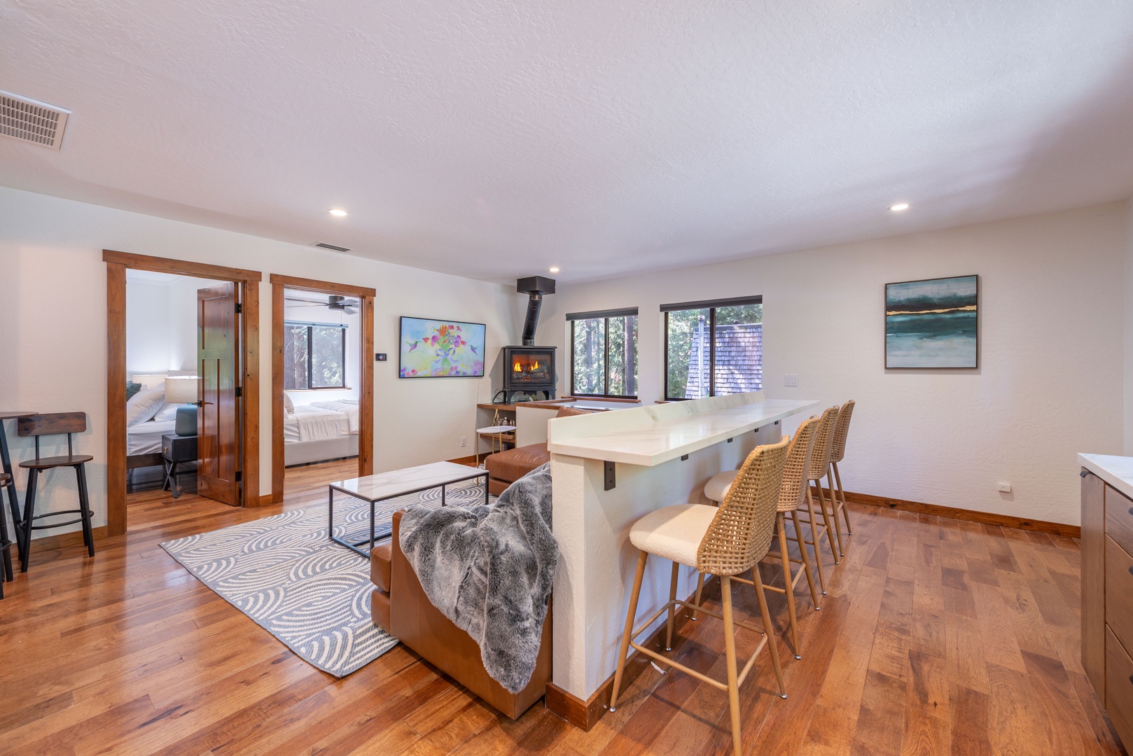 Step into this warm, open-concept space where you'll find a cozy fireplace anchoring the living area and a welcoming breakfast bar for your morning coffee or casual meals together.