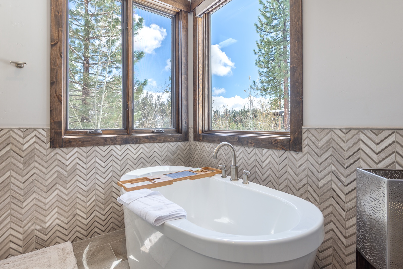 Soak in your private sanctuary with stunning forest views through corner windows, creating the perfect spa-like retreat.