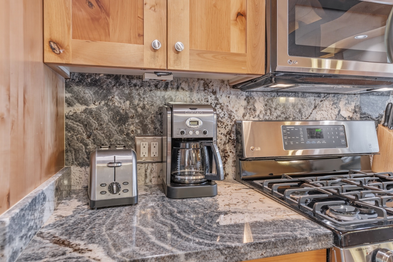 Your fully equipped kitchen features granite counters, stainless appliances, a gas range, and a coffee maker—everything you need to prepare meals with ease.