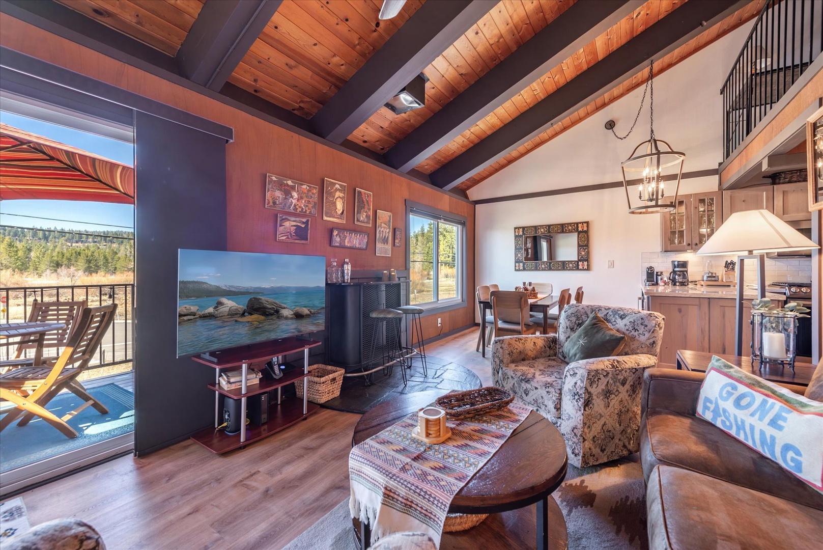 Unwind in your rustic living space with home furnishings and mountain views through picture windows.