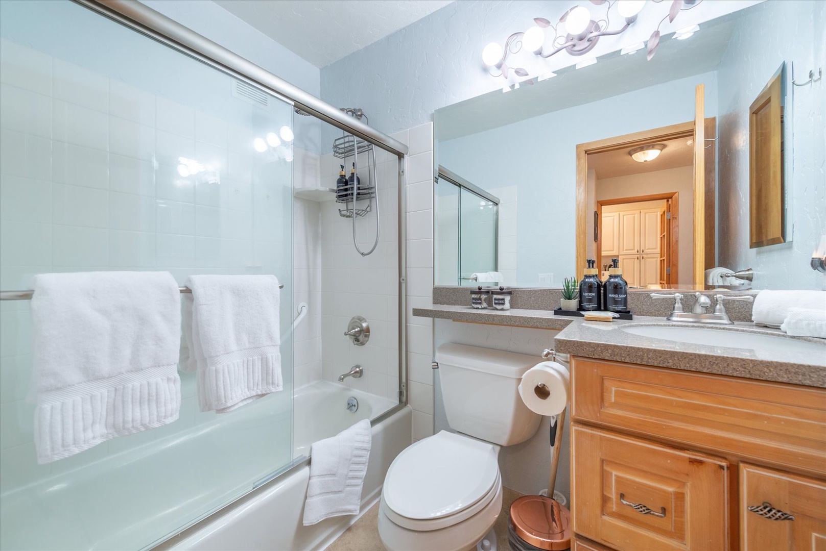 Freshen up in your bright, spotless bathroom featuring a full tub-shower combo, plush towels, and provided bathroom amenities.