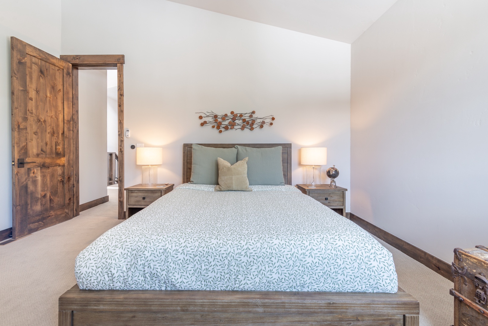 Rest easy in your serene bedroom, where rustic wood touches and soft linens create the perfect retreat for peaceful nights.
