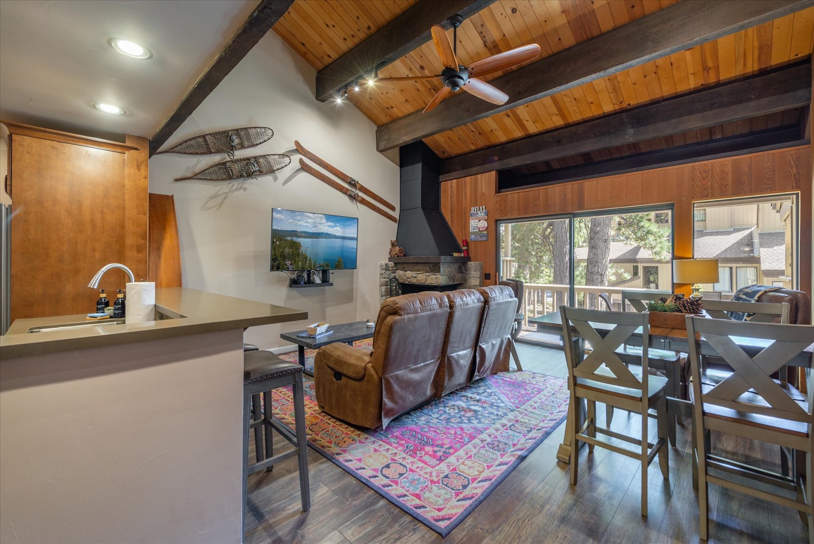Relax in your mountain retreat where rustic beams meet modern comfort, complete with stone fireplace and forest views through every window.