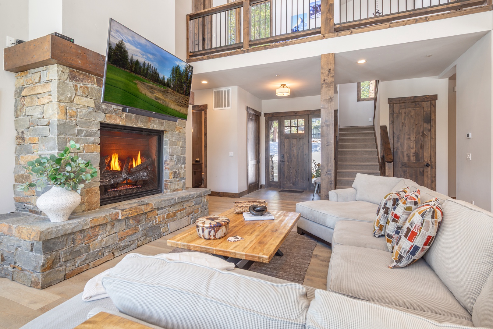 Sink into plush sofas by the crackling stone fireplace, while natural light streams through soaring windows in this beautifully appointed mountain retreat.