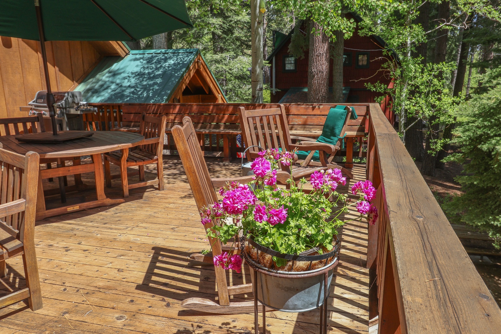 Picture yourself relaxing on this sun-drenched deck, surrounded by towering pines. The perfect spot for morning coffee or evening barbecues, with plenty of seating and forest views to unwind.