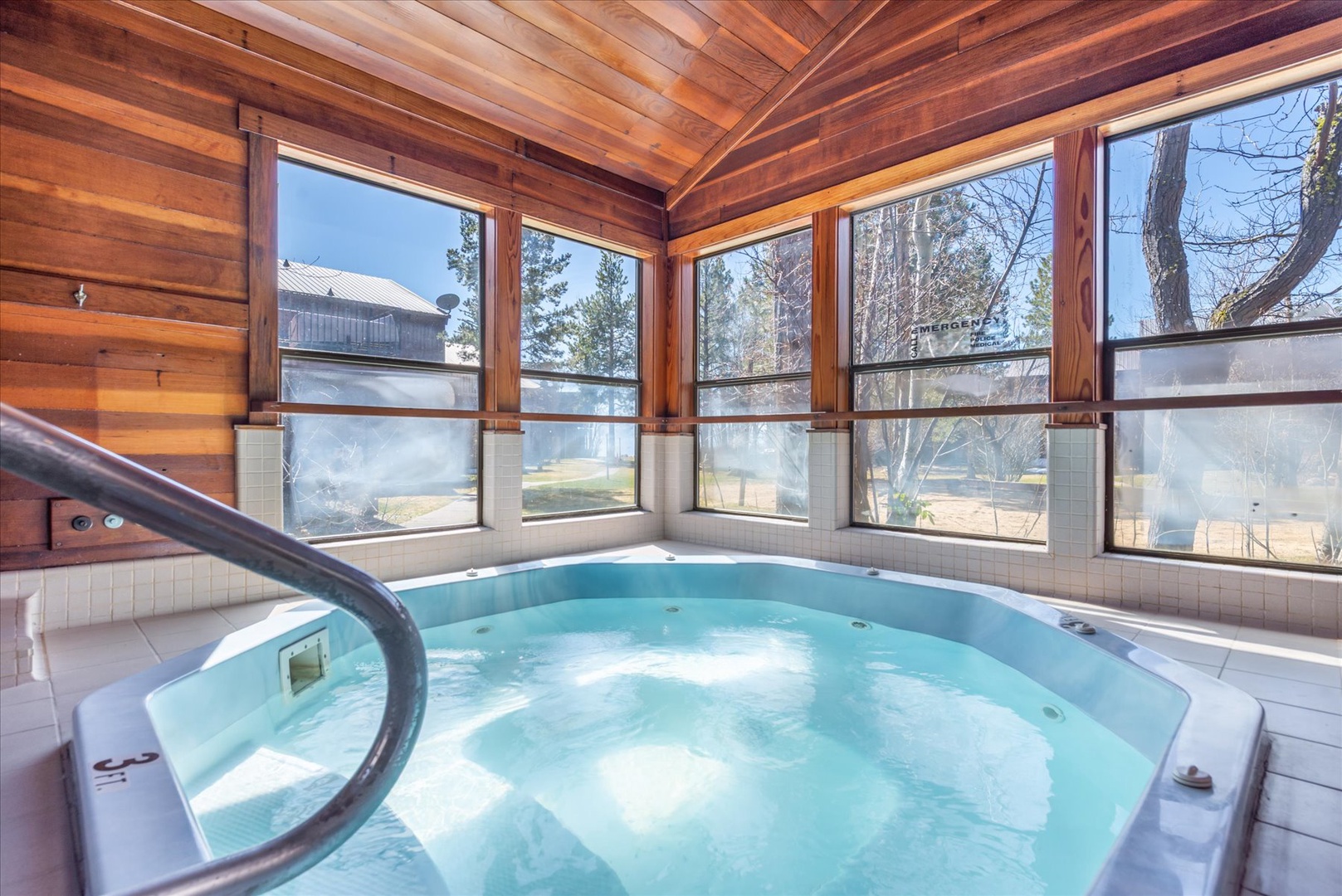 Relax in the indoor hot tub available at the condo complex surrounded by panoramic windows.