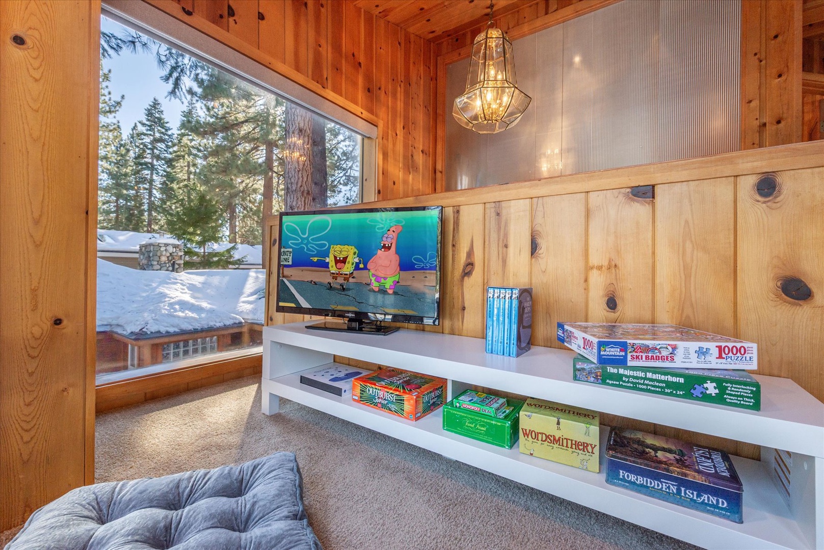 Kids will love having their own treehouse-feel nook with board games, TV, and snowy mountain views through the window.