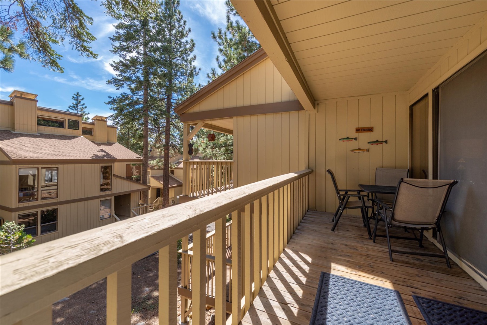 Your private balcony offers forest views and outdoor dining space, perfect for morning coffee surrounded by towering trees.