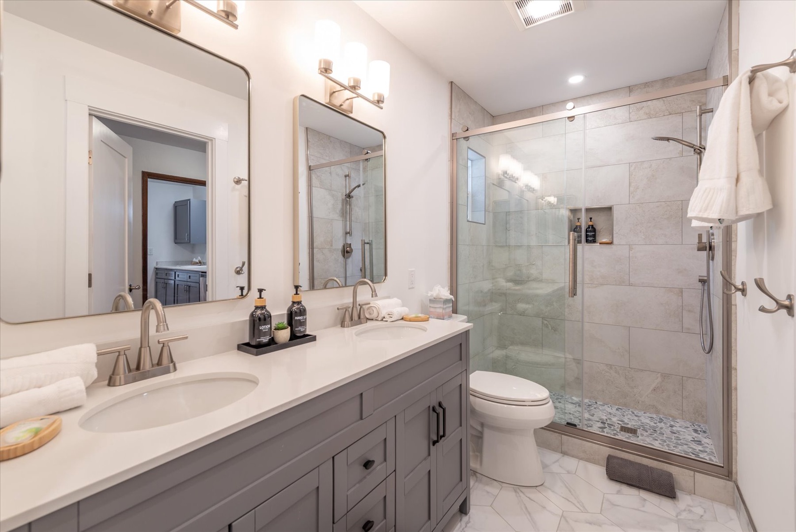 Indulge in your ensuite bathroom featuring marble finishes, dual vanities, and a luxurious walk-in shower with premium amenities.