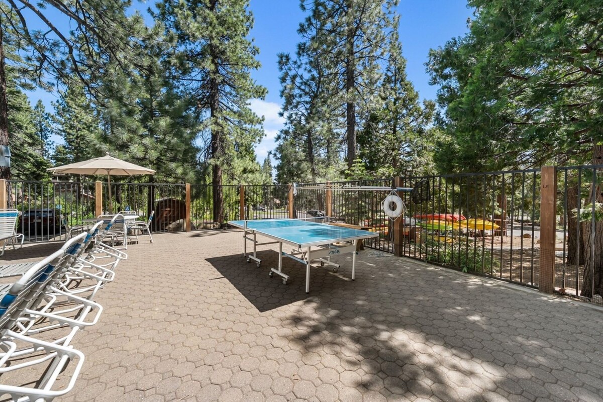 Forest setting creates natural shade for outdoor ping-pong matches and poolside relaxation.