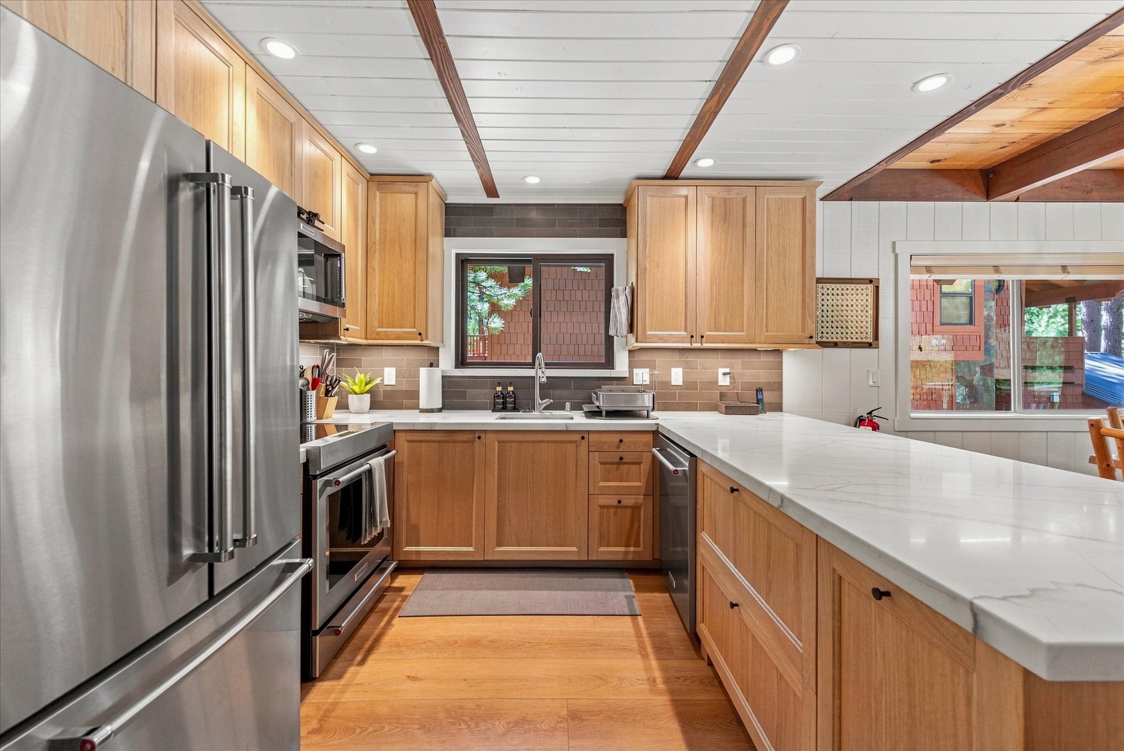 Your culinary haven features warm wood cabinetry, pristine countertops, and sleek stainless appliances—everything you need to create memorable meals in style.