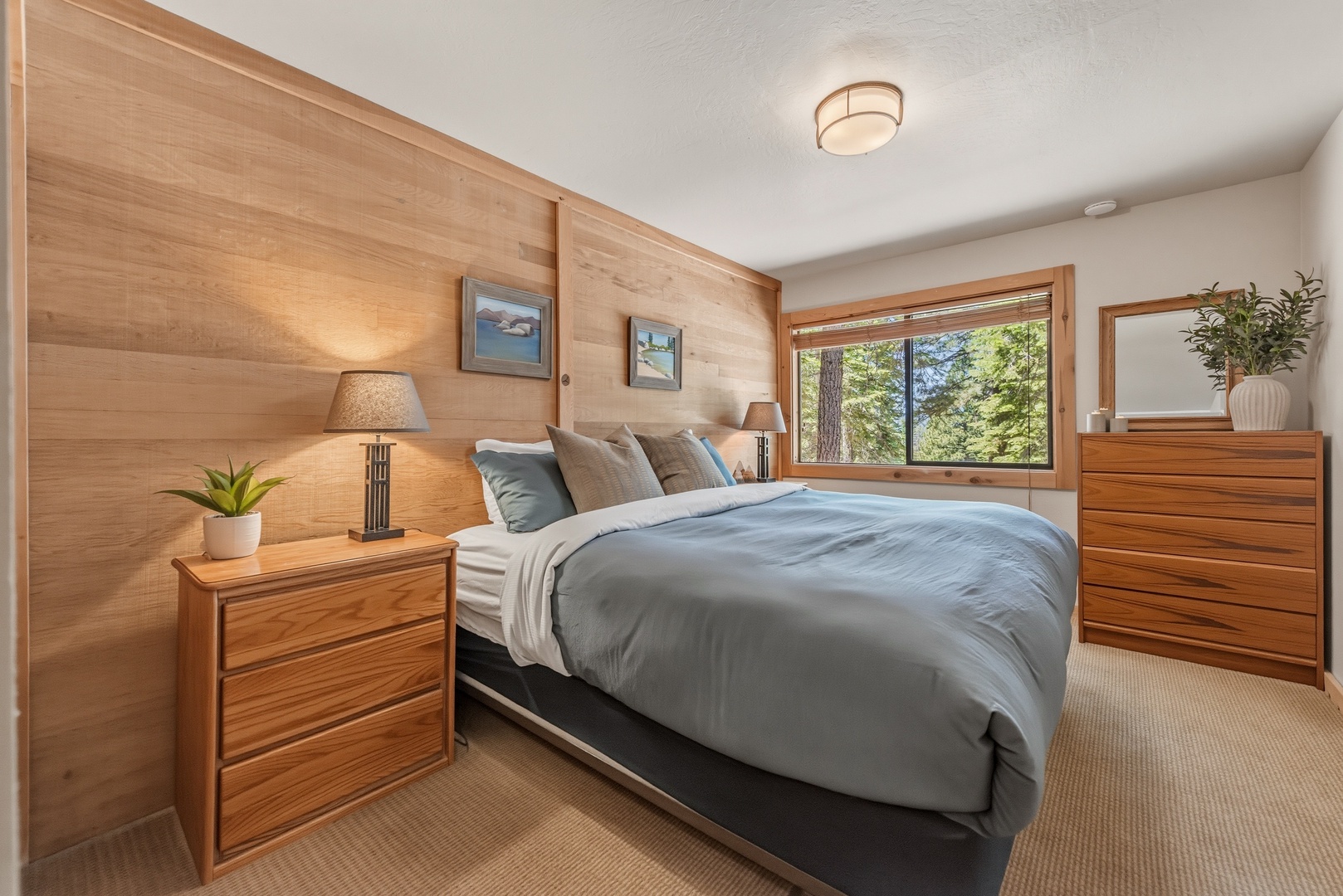 Wake up to forest views streaming through your window, where natural light meets warm wood tones and soft linens. Your serene retreat invites restful sleep surrounded by nature's beauty.