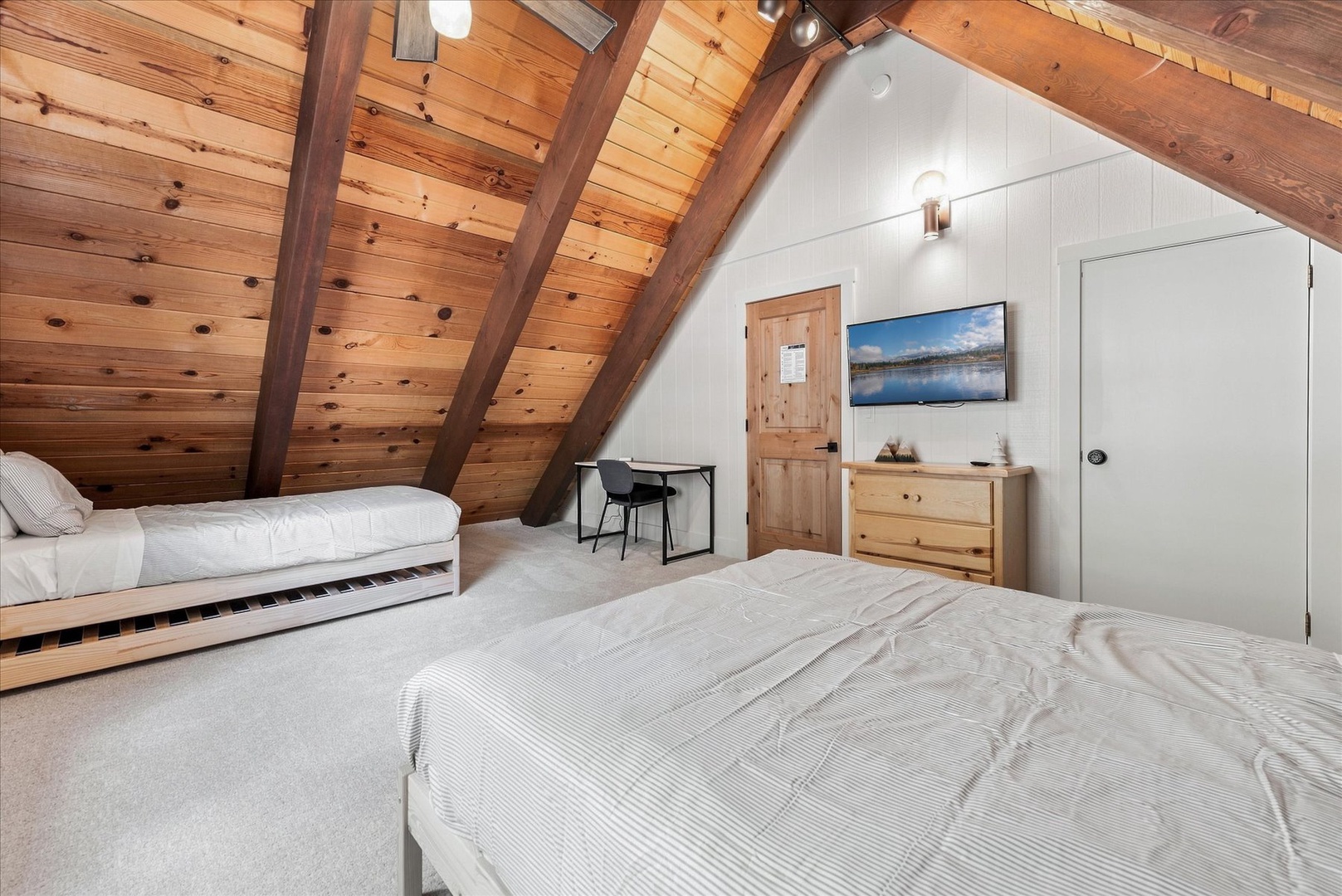 The upstairs bedroom has everything you need with your own smart TV, a work desk, plenty of space, and modular beds.