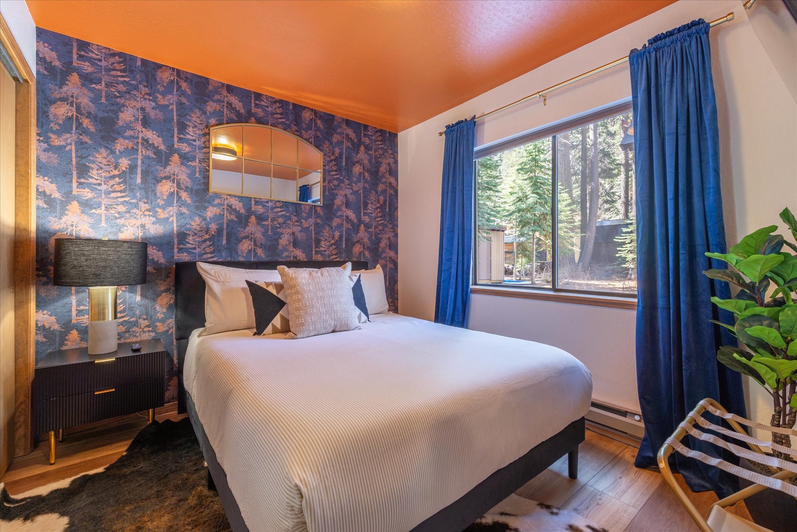 Your cozy retreat features crisp linens and forest-inspired wallpaper that creates the perfect mountain getaway ambiance.