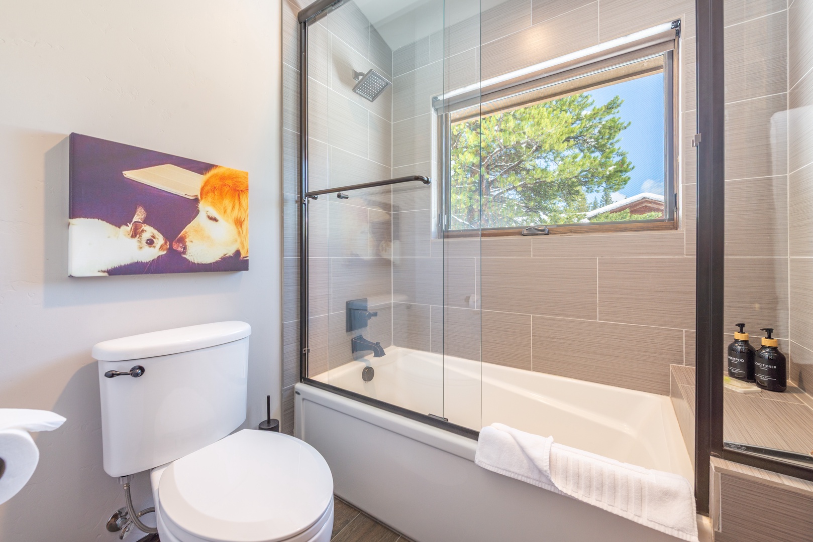 Step into your sleek bathroom featuring a luxurious soaking tub, rainfall shower, and thoughtful amenities for your perfect retreat.