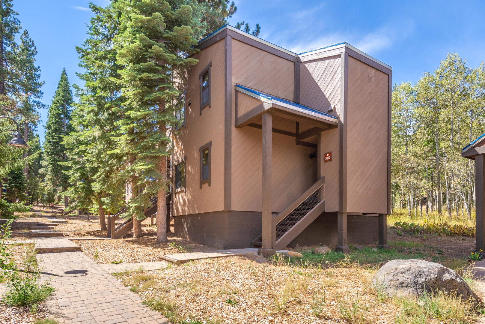 A contemporary alpine retreat nestled among tall pines and aspens, with a private setting in a peaceful mountain neighborhood.