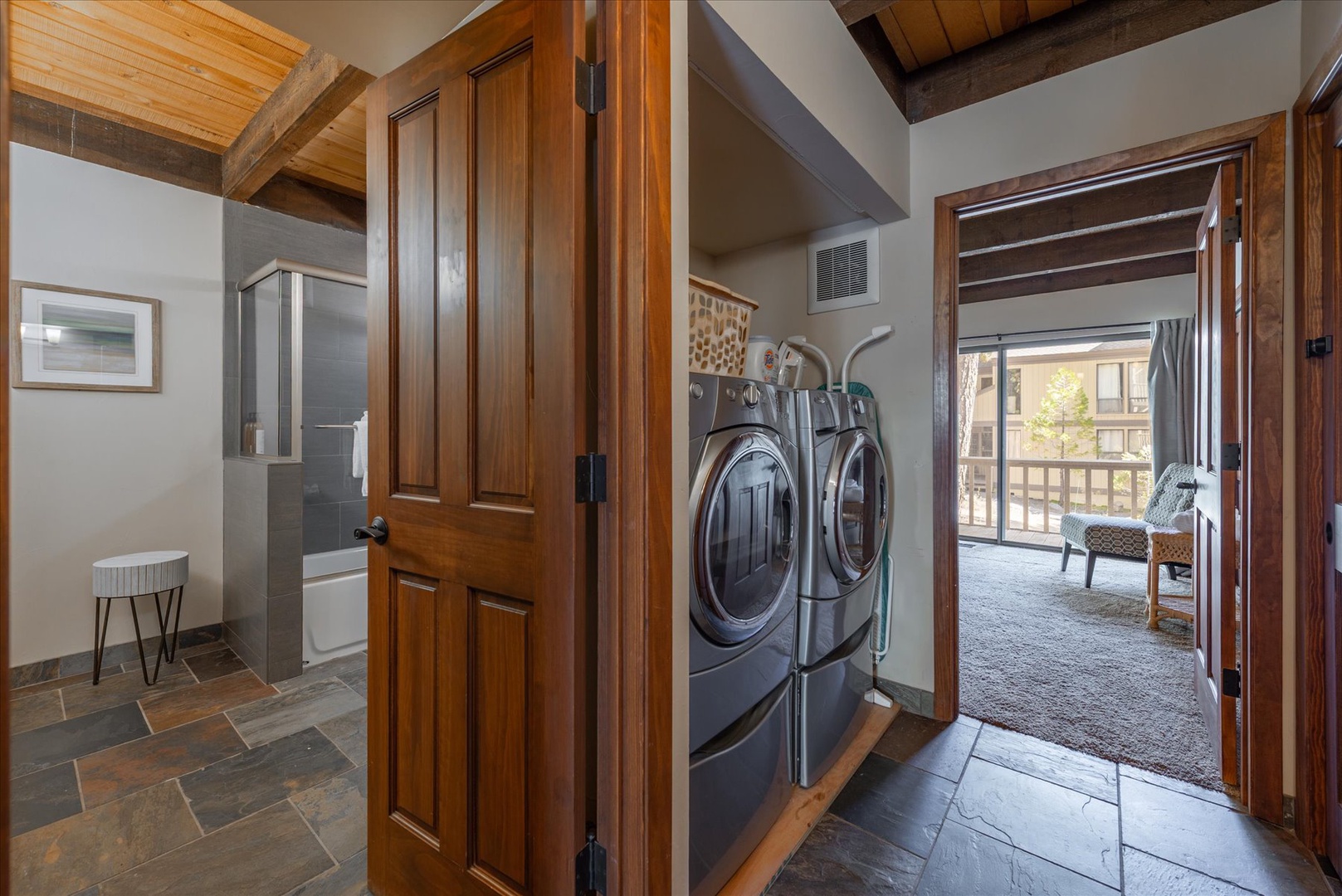 Your private laundry area features premium appliances and rustic wood details, making chores feel effortless during your stay.